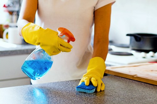 Technician performing deep upholstery cleaning on a sectional sofa